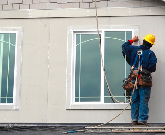 Construction worker installing a window